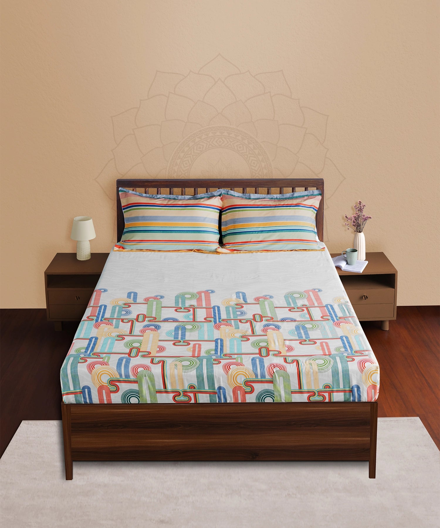 Bed with colorful geometric patterned bedspread in a bedroom setting.